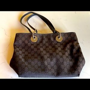 Traditional Gucci canvas tote with leather straps.